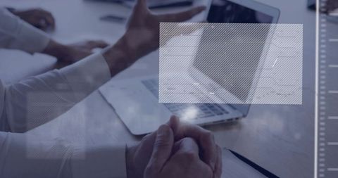 Clasping hands in boardroom with laptop and data overlay representing teamwork and strategy