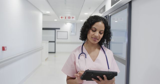 Confident Nurse Using Digital Tablet in Modern Hospital Hallway - Download Free Stock Images Pikwizard.com