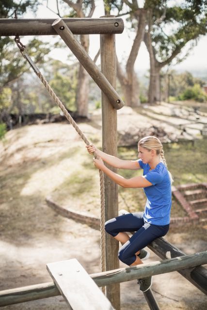 Fit Woman Climbing Rope in Outdoor Obstacle Course - Download Free Stock Images Pikwizard.com