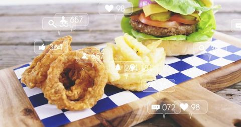 Gourmet burger with onion rings garnished by digital social icons