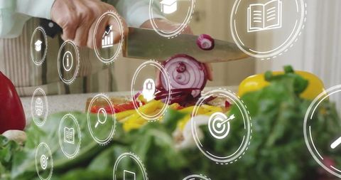 Woman slicing red onion with digital ui overlay, fresh peppers and greens on counter