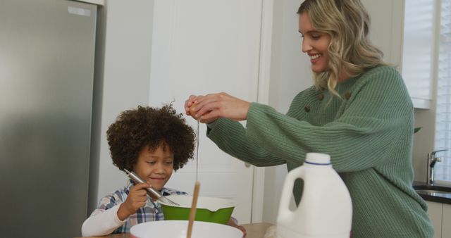Image of biracial son and caucasian mother cooking together. Family life, spending time together with family.