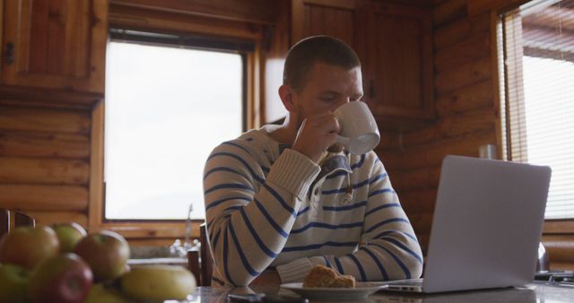 Man Working from Home in Wooden Cabin Interior, Drinking Coffee - Download Free Stock Images Pikwizard.com