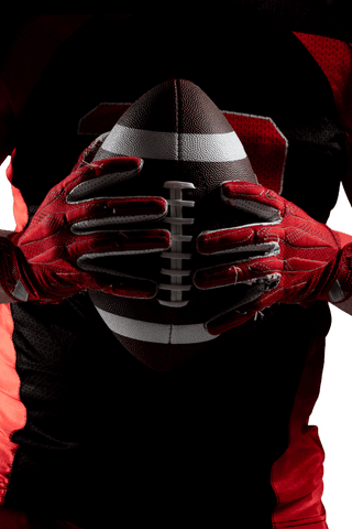 American football player holding rugby ball with transparent background