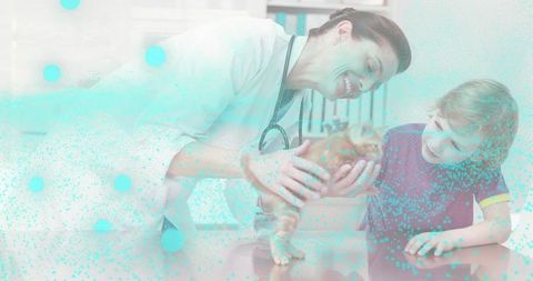 Veterinarian cradling orange tabby kitten while smiling at child during clinic exam showing compassi