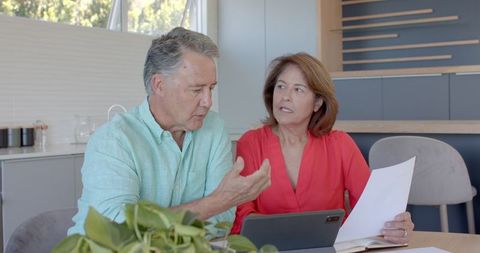 Senior Couple Engaging in Financial Planning with Tablet at Home