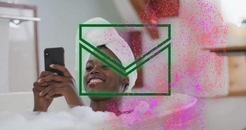 Relaxed Woman with Smartphone Enjoying Aromatic Bath