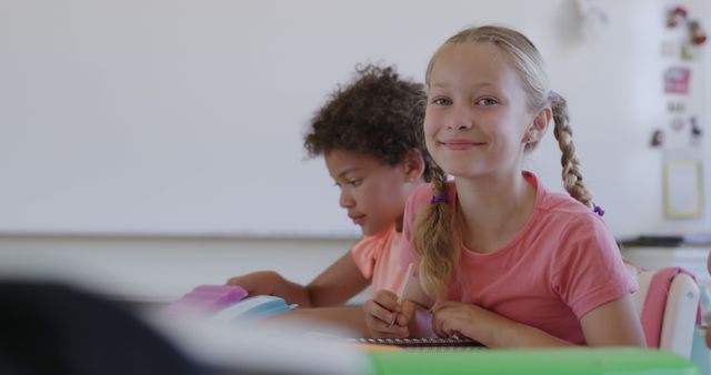 Smiling Young Girl in Classroom Working on Homework - Download Free Stock Images Pikwizard.com