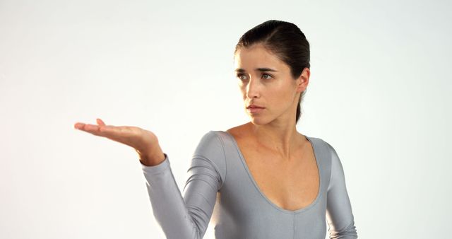 Focused Woman in Ballet Pose with Raised Hand - Download Free Stock Images Pikwizard.com