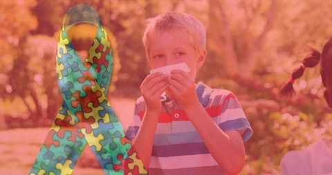 Autism awareness concept with puzzle ribbon and child