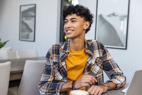 Young Man Enjoying Coffee in Modern Cozy Dining Room