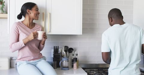 Couple Enjoying Conversation in Modern Kitchen Setting