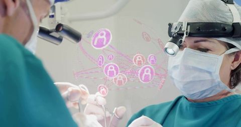 Operating surgeon wearing headlamp performing precision surgery with holographic overlay