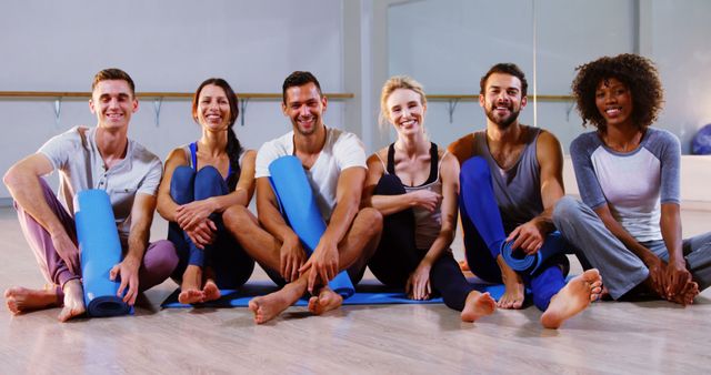 Diverse Group of Young Adults Smiling and Sitting with Yoga Mats in Studio - Download Free Stock Images Pikwizard.com