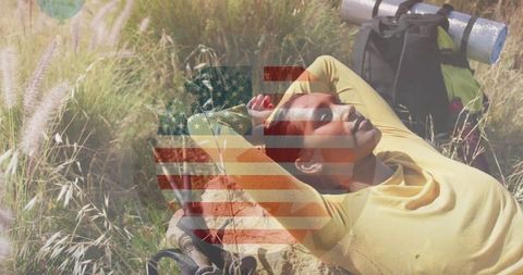 Relaxed Hiker Enjoying Nature in Mountain Scenery with American Flag Overlay