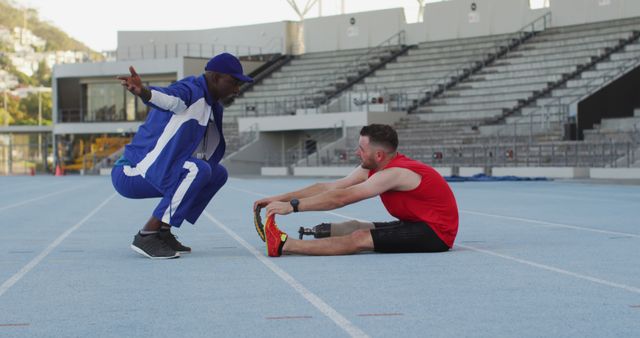 Personal Trainer Coaching Athlete Stretching on Track Field - Download Free Stock Images Pikwizard.com