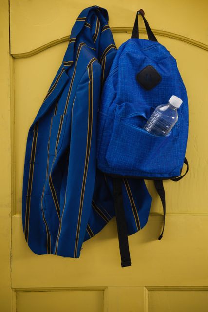 School uniform and bag hanging on door - Download Free Stock Photos Pikwizard.com