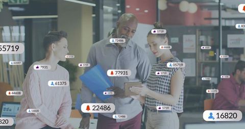 Diverse team collaborating with tablet and notification overlays in modern coworkorking space