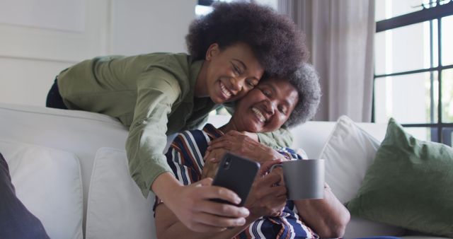 Granddaughter Taking Selfie with Elderly Grandmother on Couch - Download Free Stock Images Pikwizard.com