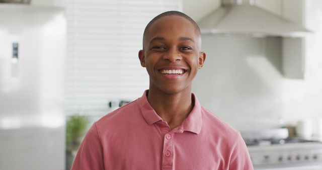 Image of happy african american boy looking at camera in kitchen - Download Free Stock Photos Pikwizard.com