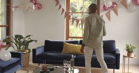 Man Dancing at Home Birthday Party with Decorations