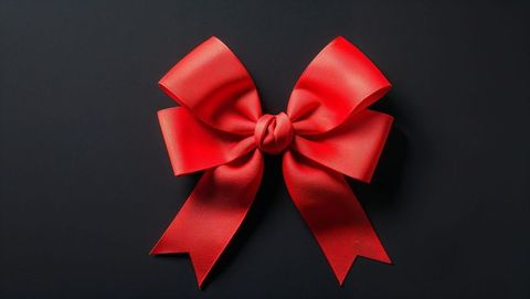 Elegant red ribbon bow on dark background