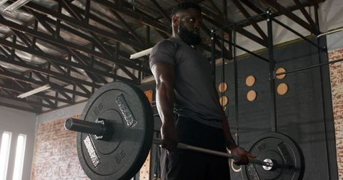 Man Performing Deadlift in Industrial Gym Environment