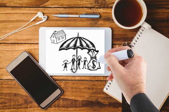 Hand drawing family under an umbrella symbolizing protection on a tablet screen, surrounded by office supplies. Ideal for concepts related to insurance, financial security, family safety, digital creativity, and workspace setup.