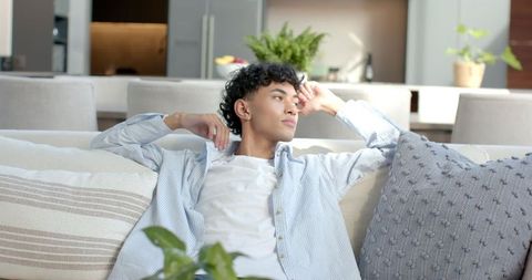 Relaxed young man enjoying modern living room ambiance