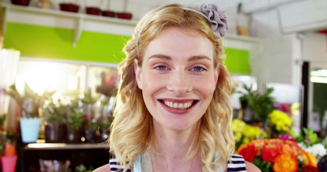 Smiling Woman in Flower Shop Surrounded by Bright Blooms - Download Free Stock Images Pikwizard.com