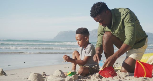 Father and Son Building Sandcastles on Beach - Download Free Stock Images Pikwizard.com