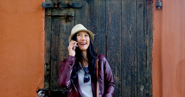 Happy Woman in Hat Talking on Phone Against Rustic Background - Download Free Stock Images Pikwizard.com