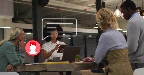 Presenting tablet-led team collaboration with chat overlay, laptop, modern coworking space