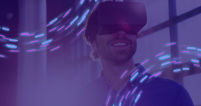 Man using VR headset experiencing digital technology with neon light effects. Ideal for illustrating concepts of virtual reality, futuristic gaming, technology innovations, digital experiences, and immersive environments.