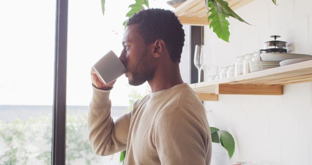 Young Man Drinking Coffee, Enjoying a Relaxed Morning at Home - Download Free Stock Images Pikwizard.com