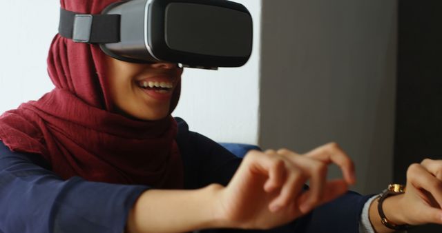 Muslim Woman Enjoying Virtual Reality Experience in Modern Setting - Download Free Stock Images Pikwizard.com