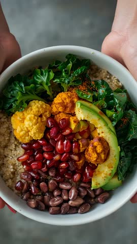 Hands Presenting Vibrant Plant-Based Power Bowl While Tilting to Reveal Ingredients Vertical Video