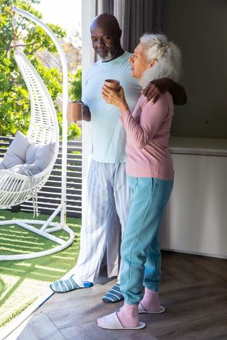 Senior Couple Relaxing with Coffee in Cozy Morning Light