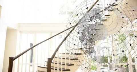 Sunlit curved wooden staircase rising in modern foyer with wireframe globe network overlay