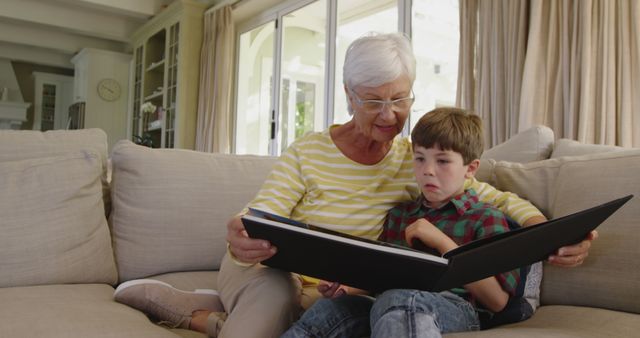 Grandmother and Grandson Sharing Story Time on Cozy Sofa - Download Free Stock Images Pikwizard.com