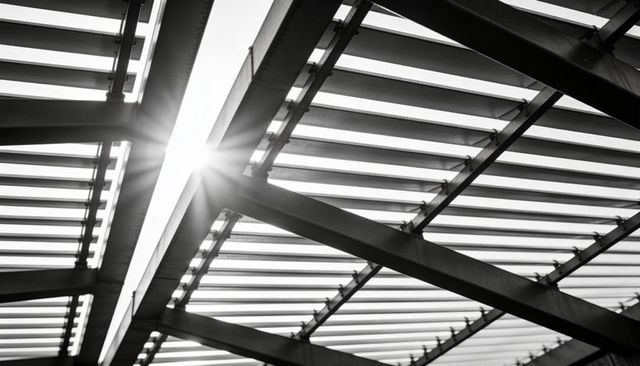 Sunburst through steel canopy slats — diagonal beams creating geometric roof structure