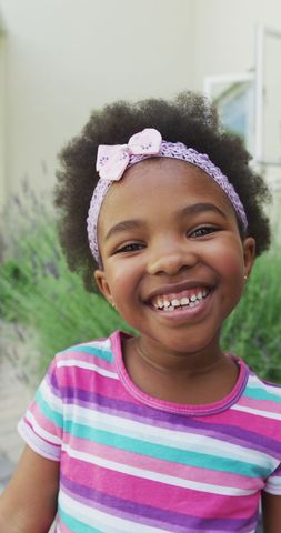 Smiling Young Girl in Bright Garden Apparel