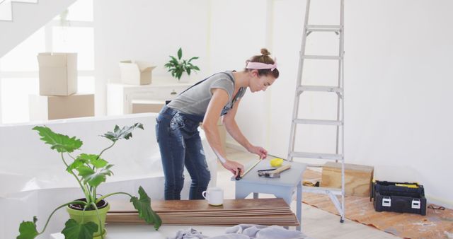 Young woman preparing to paint modern living room - Download Free Stock Images Pikwizard.com