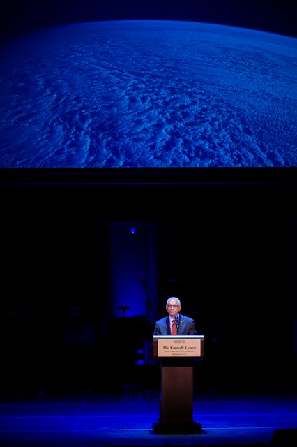 NASA Administrator Charles Bolden is seen making an important announcement during a tribute event for Sally Ride at the John F. Kennedy Center for the Performing Arts in Washington, DC on May 20, 2013. There is a projection of Earth above the stage, highlighting the theme of space exploration. This image is perfect for use in articles, presentations, and posters related to space history, tributes to influential figures, and NASA events.