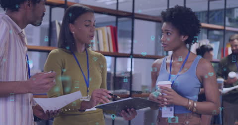 Diverse Professionals Collaborating in a Modern Office with Digital Icons