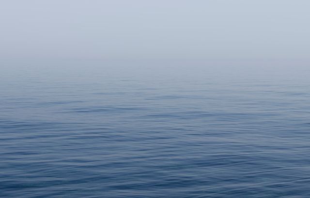 Calm Sea Horizon under Misty Sky - Download Free Stock Photos Pikwizard.com