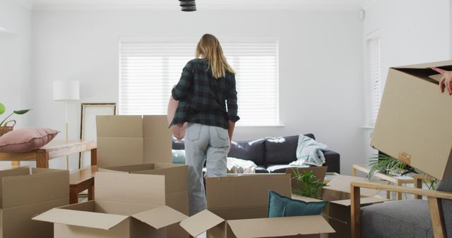 Young Woman Moving into New Home with Cardboard Boxes - Download Free Stock Images Pikwizard.com