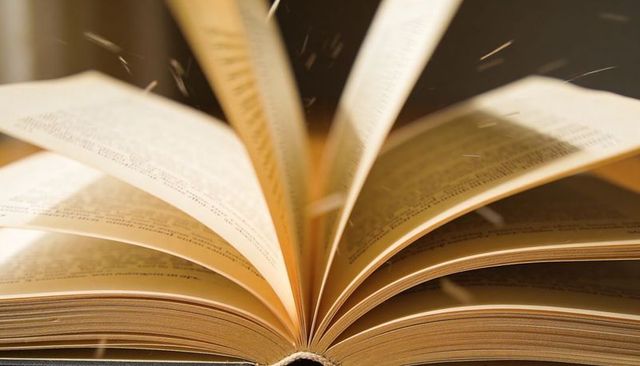 Fanning Paperback Pages Forming Curved Lines and Floating Dust in Warm Golden Light