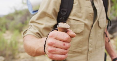 Survivalist Hiker Traversing Wilderness with Walking Stick - Download Free Stock Images Pikwizard.com