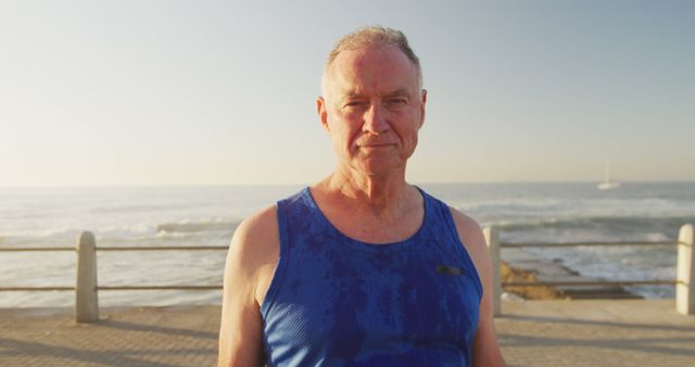 Senior man in blue tank top enjoying a coastal jog - Download Free Stock Images Pikwizard.com